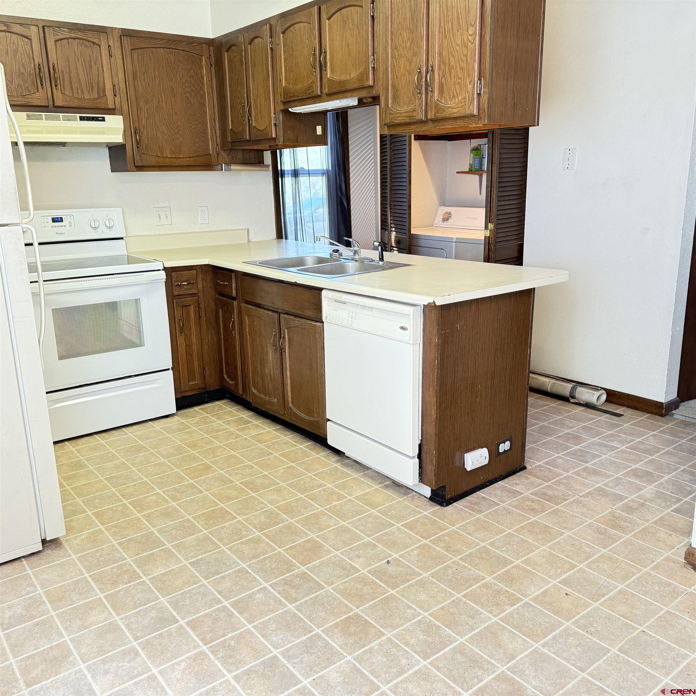 1021 West Denver Avenue, Unit 4 Gunnison, CO 81230 - Photo 17 of 26 a kitchen with a sink cabinets and appliances