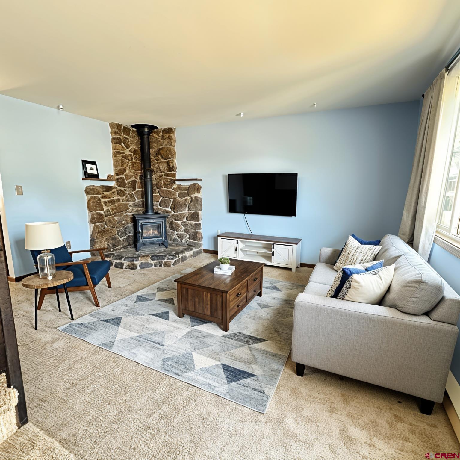 1021 West Denver Avenue, Unit 4 Gunnison, CO 81230 - Photo 2 of 26 a living room with furniture and a flat screen tv