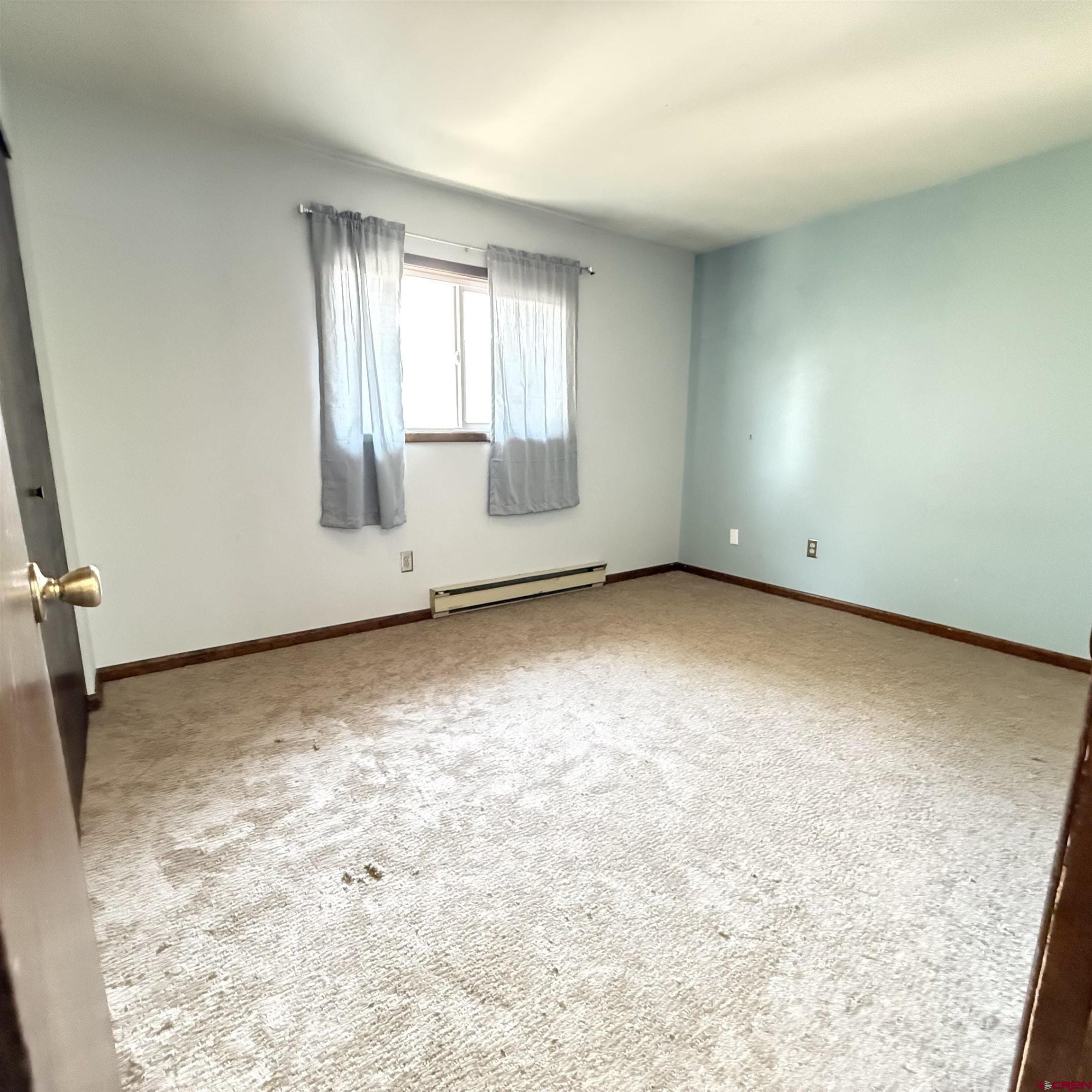 1021 West Denver Avenue, Unit 4 Gunnison, CO 81230 - Photo 25 of 26 an empty room with windows