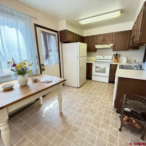 a kitchen with stainless steel appliances a refrigerator and a stove top oven