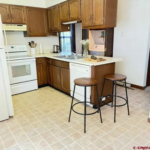 a kitchen with a sink cabinets and window