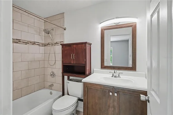 an empty room with windows and cabinet