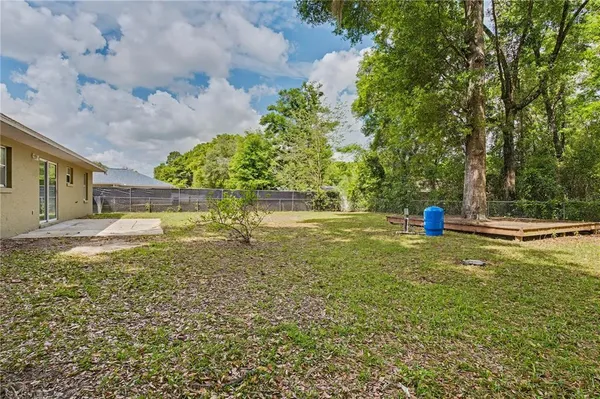 a backyard of a house with table and chairs