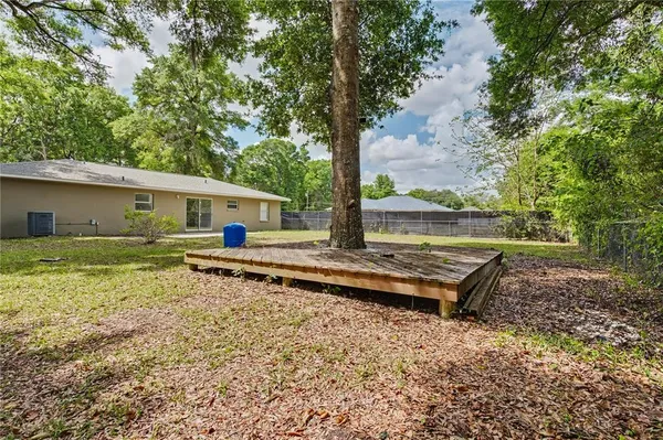 a front view of house with yard and trees