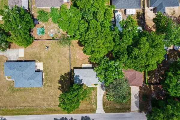 an aerial view of a house with outdoor space and street view