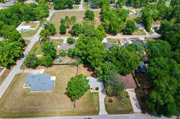 an aerial view of a house with a yard and garden