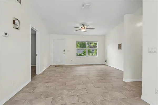 an empty room with windows and closet