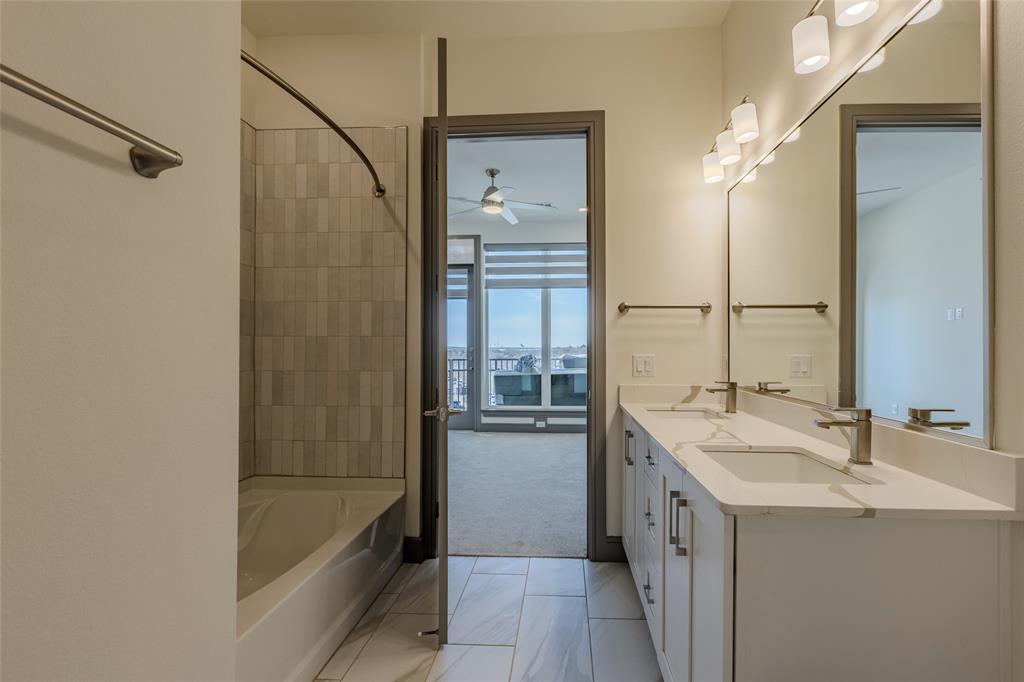 2700 Old Denton Road, Unit 4473 Carrollton, TX 75007 - Photo 11 of 27 a bathroom with a tub sink and mirror