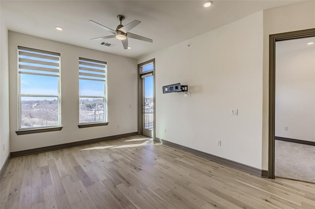 2700 Old Denton Road, Unit 4473 Carrollton, TX 75007 - Photo 3 of 27 wooden floor in an empty room with a window