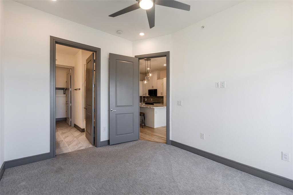 2700 Old Denton Road, Unit 4473 Carrollton, TX 75007 - Photo 9 of 27 an empty room with closet and a ceiling fan