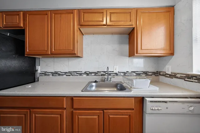 a kitchen with a sink and cabinets