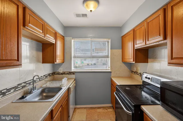 a kitchen with a stove a sink and a microwave