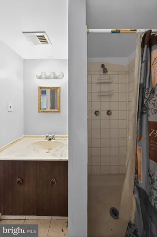 a bathroom with a double vanity sink a toilet and shower