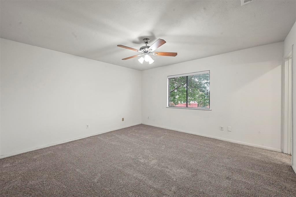 718 Roaming Rd Drive Allen, TX 75002 - Photo 15 of 21 Spare room featuring dark colored carpet and ceiling fan