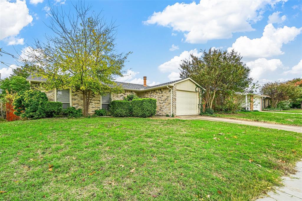 718 Roaming Rd Drive Allen, TX 75002 - Photo 2 of 21 View of front of home featuring a front yard, a garage, driveway, a chimney, and brick siding