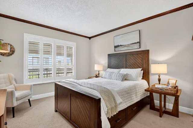 a bedroom with a bed couch and window