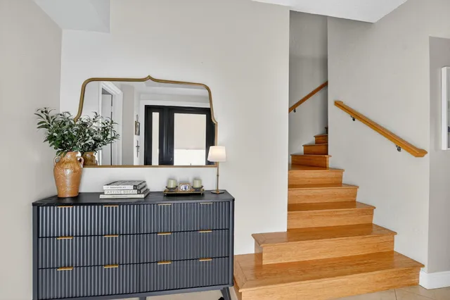 a kitchen with a stove and a potted plant