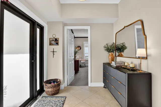 a view of a hallway with living room and furniture