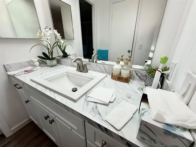 a bathroom with a double vanity sink and mirror