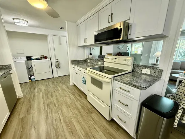 a kitchen with sink cabinets and window