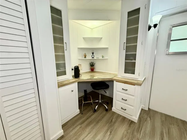 a view of a room with wooden floor and furniture