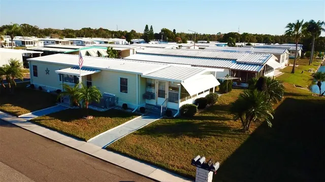a view of a house with pool and chairs