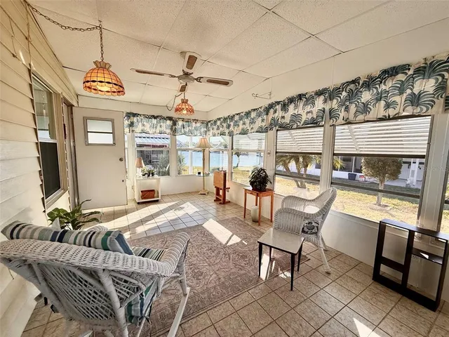 a view of a livingroom with furniture and a floor to ceiling window