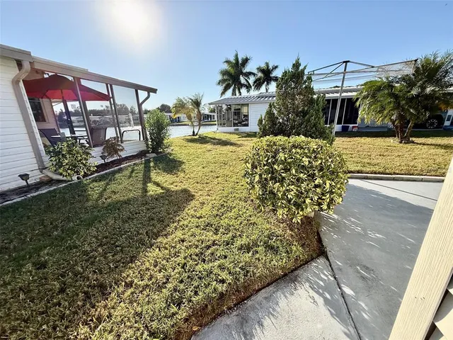 a view of a house with pool and chairs