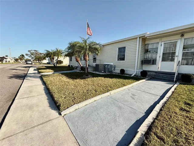 a view of a patio with lawn chairs