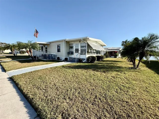 an aerial view of a house swimming pool and outdoor seating