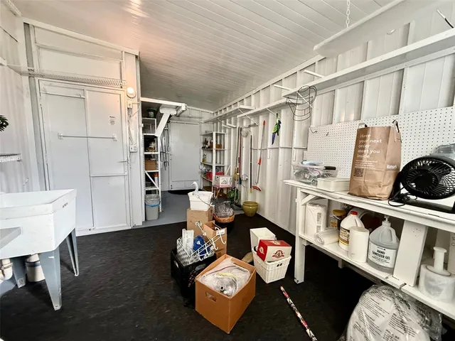 an aerial view of a city with lots of residential buildings ocean and mountain view in back