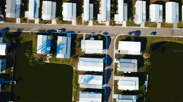 an aerial view of a house with a yard basket ball court and outdoor seating