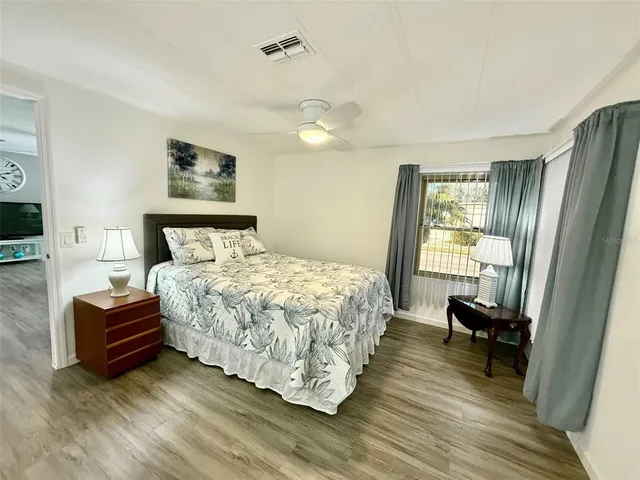 a bedroom with a bed and a large mirror
