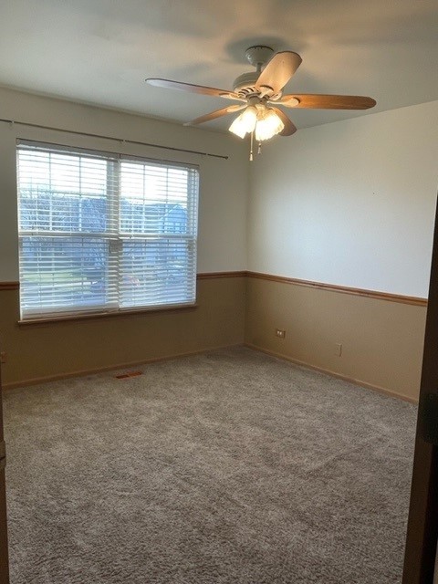 2332 Overlook Court, Unit 2332 Naperville, IL 60563 - Photo 16 of 26 an empty room with a chandelier fan and window