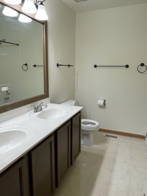 2332 Overlook Court, Unit 2332 Naperville, IL 60563 - Photo 18 of 26 a bathroom with a double vanity sink toilet and a mirror