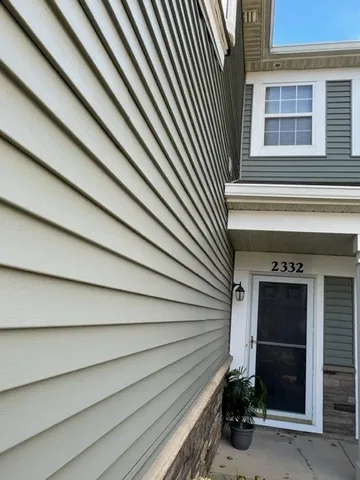 a view of a house with a door and wooden roof