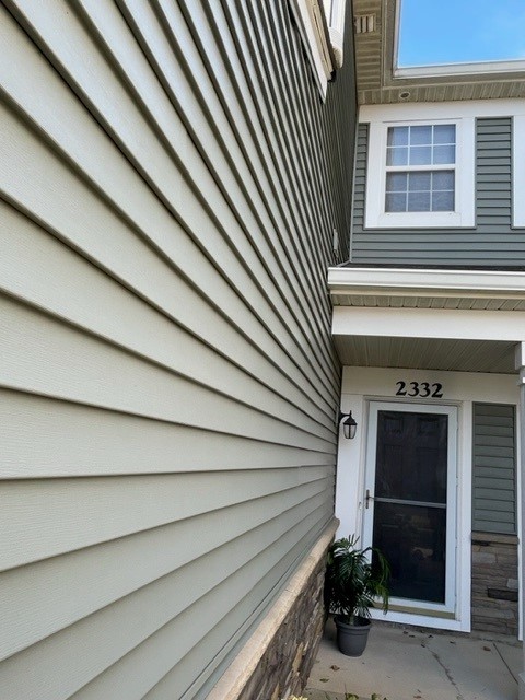 2332 Overlook Court, Unit 2332 Naperville, IL 60563 - Photo 2 of 26 a view of a house with a door and wooden roof