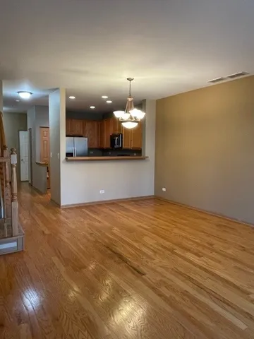 a view of an empty room and kitchen view