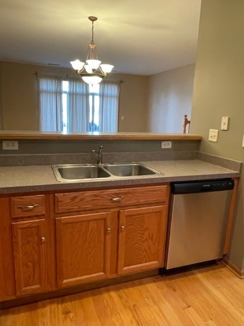 2332 Overlook Court, Unit 2332 Naperville, IL 60563 - Photo 10 of 26 a kitchen with granite countertop a sink cabinets and wooden floor