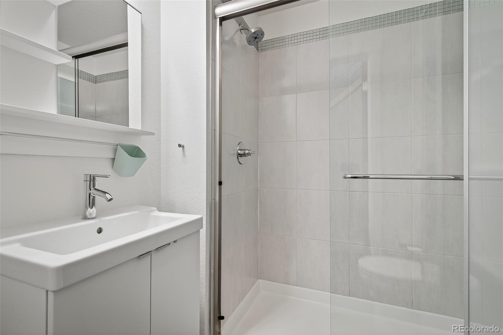 1022 West 37th Avenue Denver, CO 80211 - Photo 13 of 29 a bathroom with a sink and shower