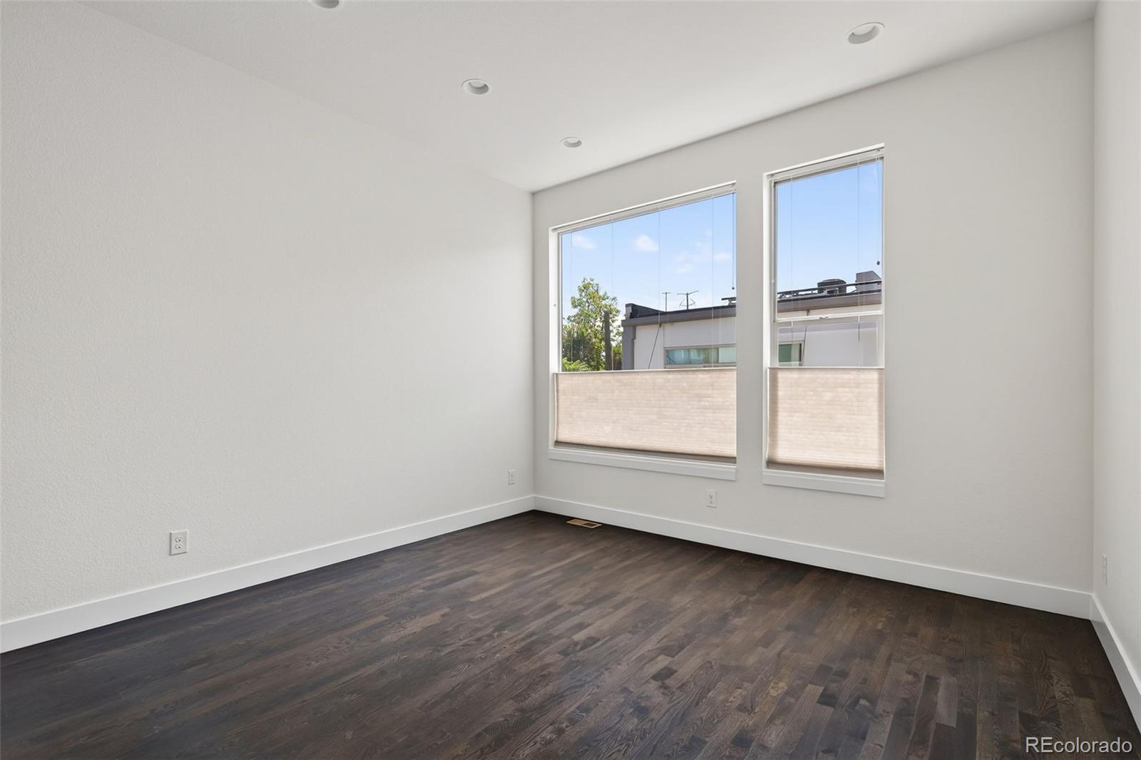 1022 West 37th Avenue Denver, CO 80211 - Photo 18 of 29 an empty room with wooden floor and windows