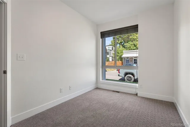 a view of a tall building next to a road