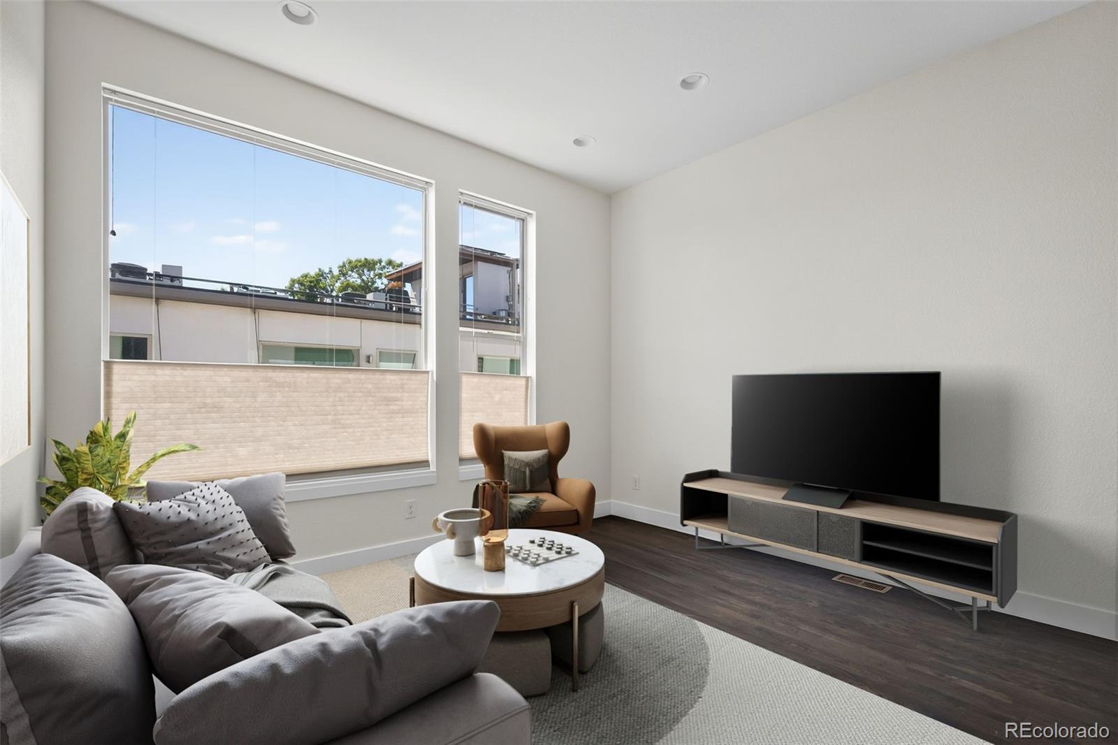 1022 West 37th Avenue Denver, CO 80211 - Photo 6 of 29 a living room with furniture and a flat screen tv