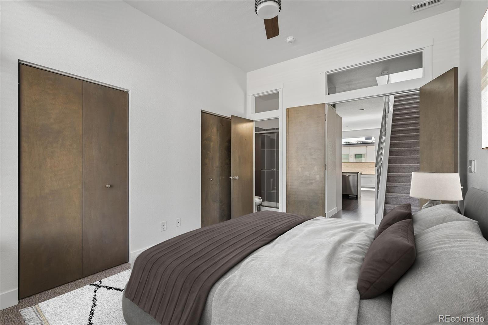 1022 West 37th Avenue Denver, CO 80211 - Photo 9 of 29 a bedroom with a large bed and a chandelier