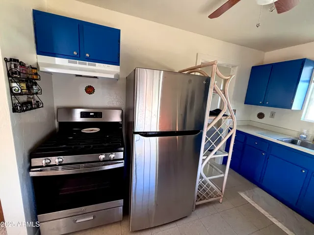 a kitchen with wooden cabinets and stainless steel appliances