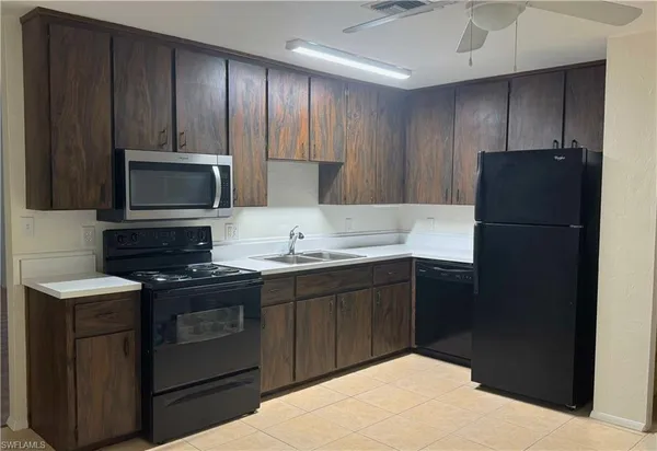 a kitchen with a sink stove and refrigerator