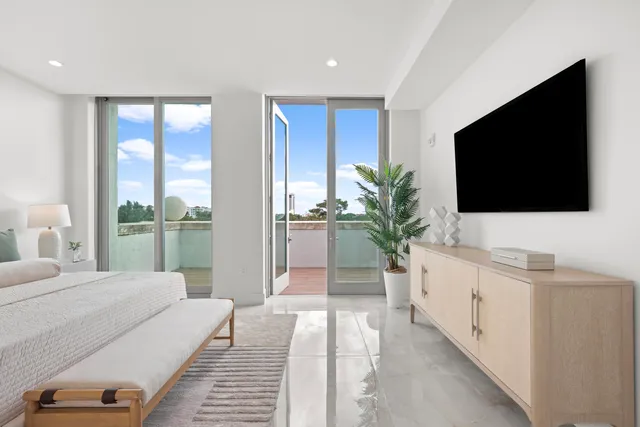 a kitchen with stainless steel appliances a sink dishwasher a refrigerator and a dining table with wooden cabinet