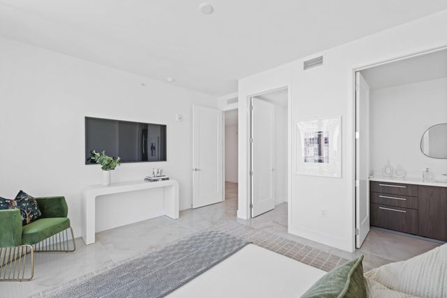 a kitchen with stainless steel appliances granite countertop a sink and a refrigerator