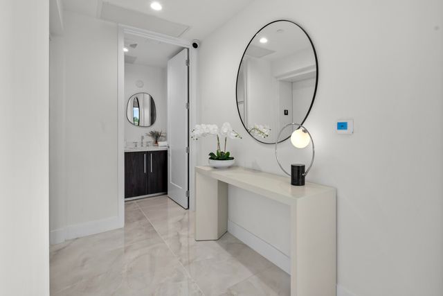 a living room with fireplace furniture and a large window
