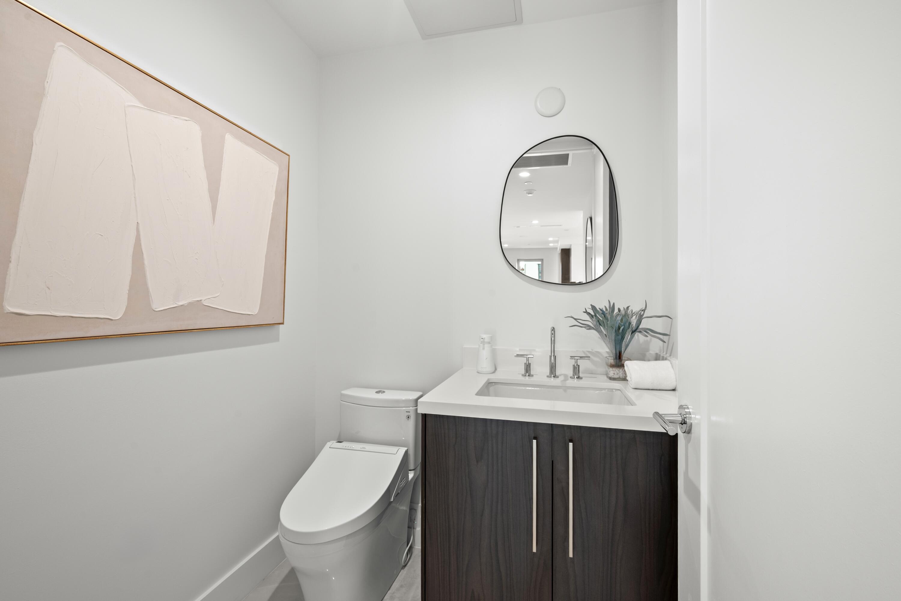 475 East Royal Palm Road, Unit 506 Boca Raton, FL 33432 - Photo 6 of 67 a bathroom with a toilet sink and mirror